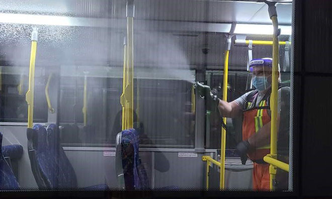 Person spraying interior of bus