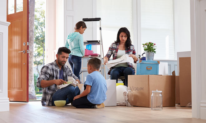 Family in new house surrounded by boxes