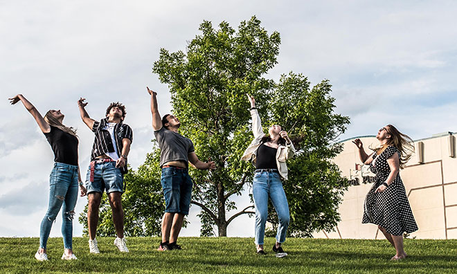 Group of youth celebrating by Festival Place