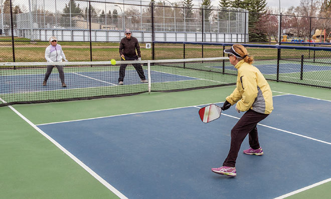 Older adults playing pickle ball