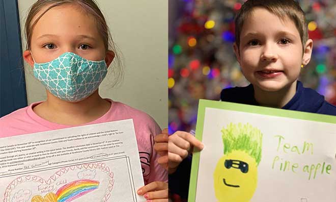 Children holding up pictures of masks