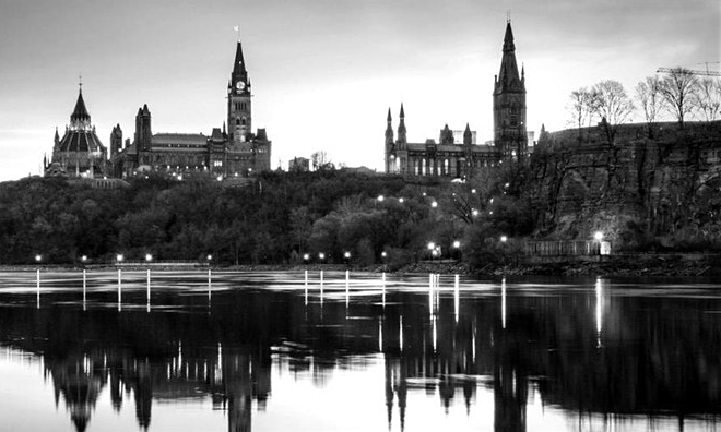 Canadian legislative building overlooking a large body of water