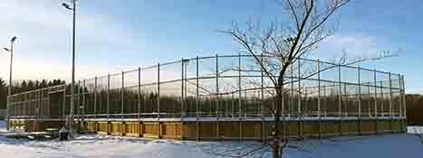 Exterior of boarded rink in winter day