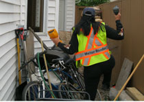 Utility worker trying to get to a remote meter reader through obstacles