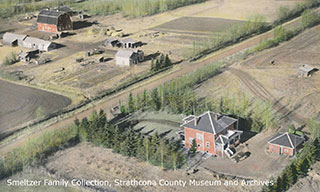 Aerial of Smeltzers’ 1920 brick house and garage, with the home quarter in the background; date unknown (Smeltzer Family Collection, Strathcona County Museum and Archives)