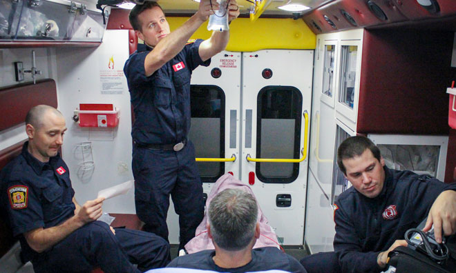 Paramedics with patient in ambulance
