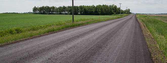 Gravel Road Maintenance Program Strathcona County - image showing a dust controlled gravel road