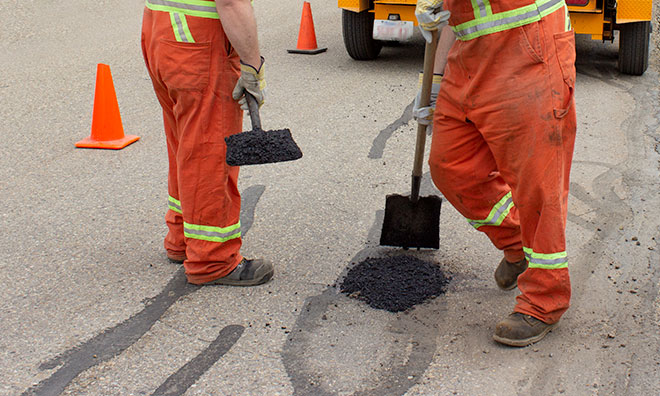Crews working to fill a pothole.