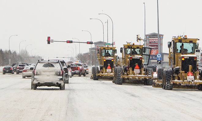 Graders clearing Baseline Road after a snow fall
