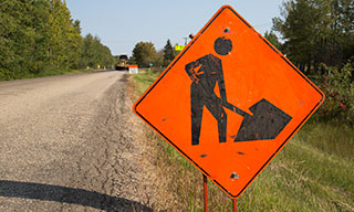 Construction sign near rural road construction.