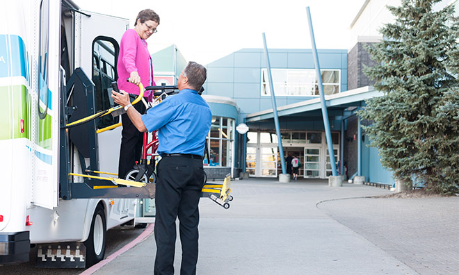 Person being assisted off a mobility bus