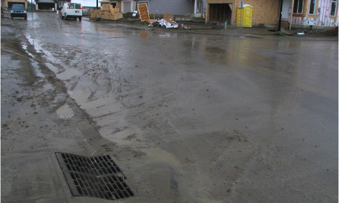 Strormwater runoff carrying sediment running into storm sewer in new housing development.