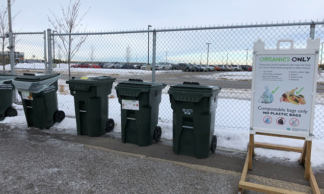 Green carts at the Broadview Enviroservice station Image of green organics carts against a chainlink fence.