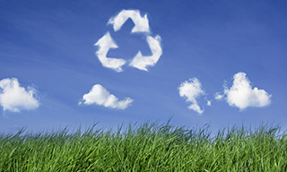 Recycling symbol drawn over sky with cloud-like shape